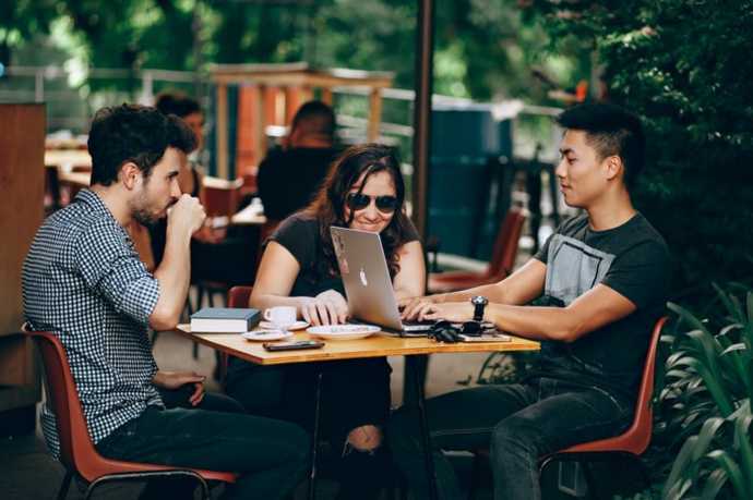 programmers sitting together at an outdoor cafe