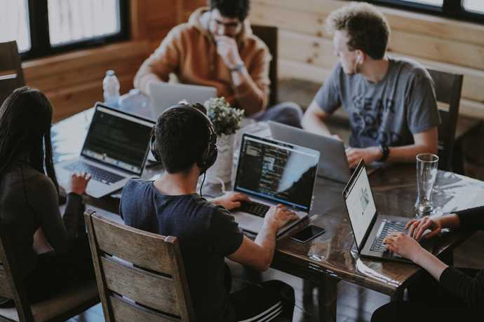 Group of developers sitting around laptops