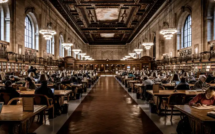 Grand library filled with people studying at tables